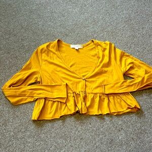 Cute crop top with vneck and ruffles at waist. Like new.